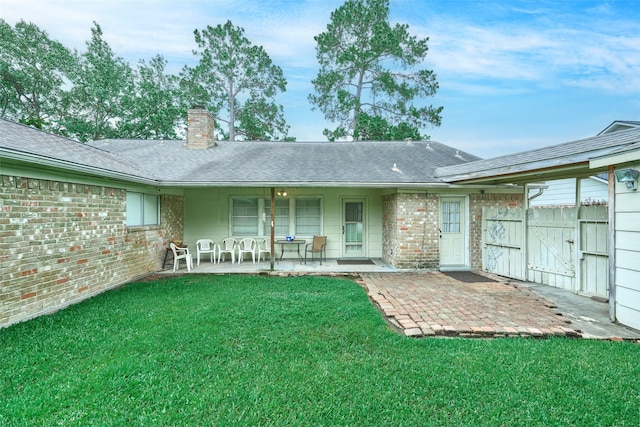 15402 Ripplestream, Houston, TX 77068 - rear view of house with a chimney, a yard, a gate, covered porch, and roof with shingles