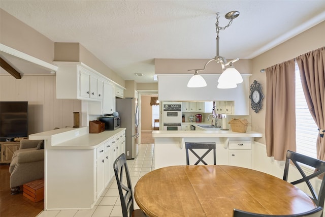 15402 Ripplestream, Houston, TX 77068 - dining space featuring light tile patterned floors and wooden walls