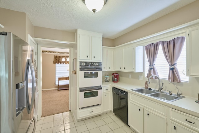 15402 Ripplestream, Houston, TX 77068 - kitchen with stainless steel refrigerator with ice dispenser, white double oven, black dishwasher, light countertops, and a textured ceiling