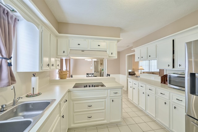 15402 Ripplestream, Houston, TX 77068 - kitchen with stainless steel appliances, light tile patterned floors, light countertops, white cabinets, and a textured ceiling