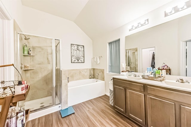 16107 Dockside St, Crosby, TX 77532 - bathroom featuring a bath, a stall shower, double vanity, vaulted ceiling, and wood finished floors