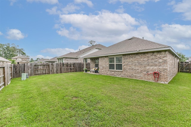 16107 Dockside St, Crosby, TX 77532 - rear view of property featuring roof with shingles, brick siding, and a fenced backyard
