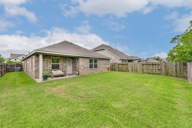 16107 Dockside St, Crosby, TX 77532 - back of property with brick siding, a fenced backyard, a patio area, and roof with shingles