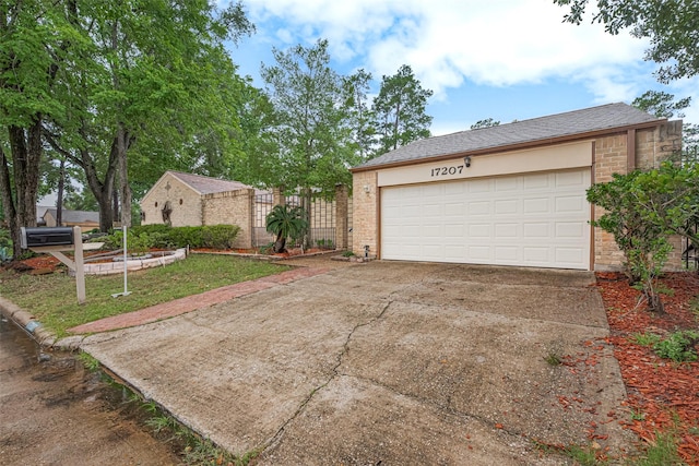 17207 Meadow Butte Dr, Houston, TX 77090 - view of front of house with a garage, concrete driveway, and brick siding
