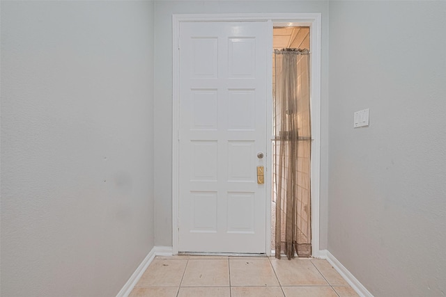 17207 Meadow Butte Dr, Houston, TX 77090 - doorway to outside featuring baseboards and light tile patterned floors