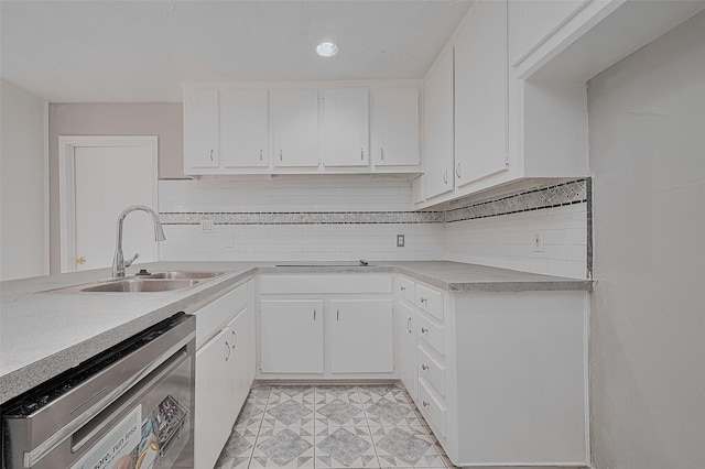 17207 Meadow Butte Dr, Houston, TX 77090 - kitchen featuring stainless steel dishwasher, light countertops, white cabinetry, tasteful backsplash, and recessed lighting