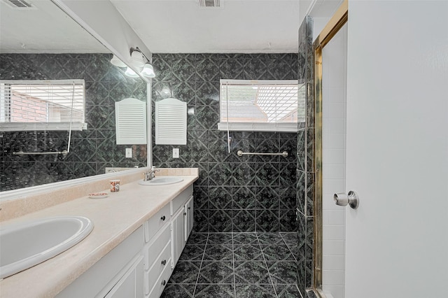 17207 Meadow Butte Dr, Houston, TX 77090 - full bath featuring double vanity, a shower stall, tile patterned flooring, and tile walls