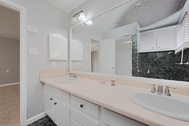 17207 Meadow Butte Dr, Houston, TX 77090 - full bath featuring double vanity, decorative backsplash, and tile patterned flooring