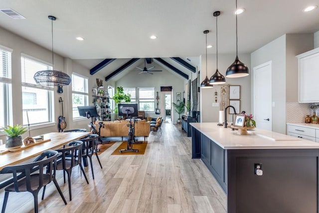 9864 Preserve Way, Conroe, TX 77385 - kitchen with light countertops, light wood-style floors, white cabinets, decorative backsplash, and ceiling fan