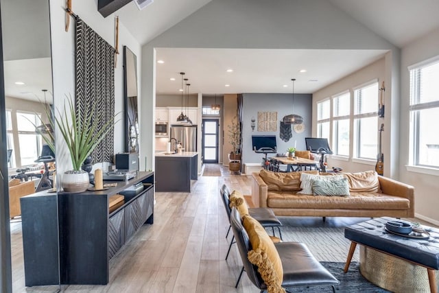 9864 Preserve Way, Conroe, TX 77385 - living room with light wood-type flooring, lofted ceiling, and recessed lighting