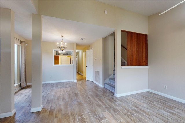 7840 Bateman Ln, Houston, TX 77088 - unfurnished room with a chandelier, light wood finished floors, and stairway