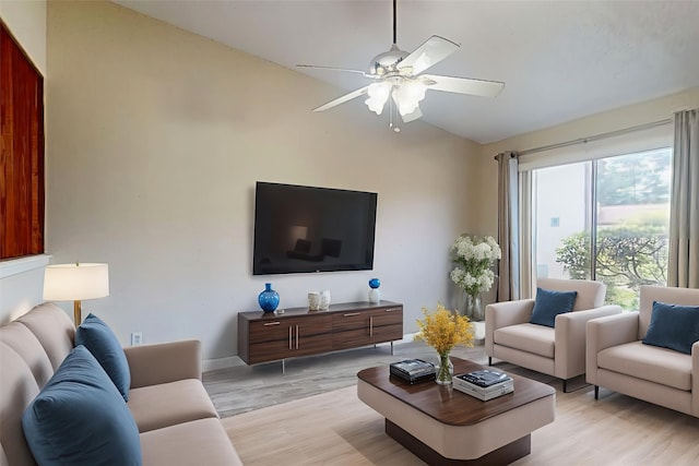 7840 Bateman Ln, Houston, TX 77088 - living room with lofted ceiling, ceiling fan, and light wood-style floors