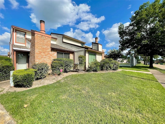 7840 Bateman Ln, Houston, TX 77088 - view of property exterior featuring a chimney and a yard
