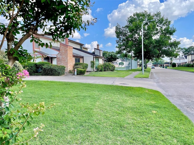 7840 Bateman Ln, Houston, TX 77088 - view of green lawn featuring a residential view