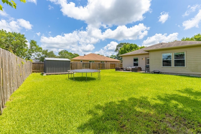 454 Fishhawk Way, Crosby, TX 77532 - fenced backyard featuring a storage unit, a trampoline, outdoor lounge area, and a patio