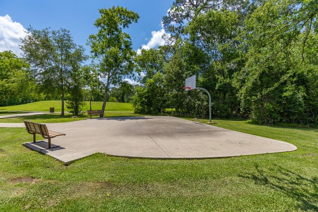 454 Fishhawk Way, Crosby, TX 77532 - view of sport court featuring basketball hoop, a yard, and view of scattered trees