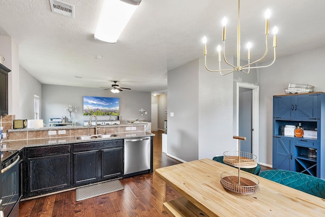 454 Fishhawk Way, Crosby, TX 77532 - kitchen featuring stainless steel appliances, dark wood-style flooring, ceiling fan, a peninsula, and a chandelier