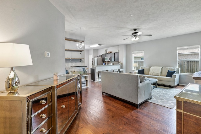 454 Fishhawk Way, Crosby, TX 77532 - living area with dark wood-style flooring, ceiling fan, and a textured ceiling