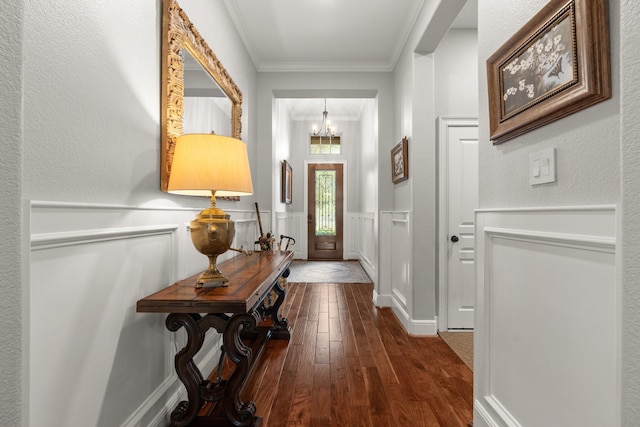 266 Tortoise Creek Pl, The Woodlands, TX 77389 - foyer with dark wood-type flooring, a chandelier, ornamental molding, and a wainscoted wall