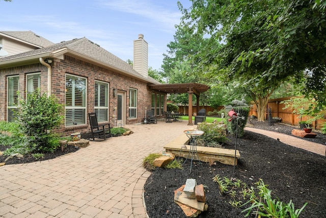 266 Tortoise Creek Pl, The Woodlands, TX 77389 - fenced backyard with a pergola, a patio area, and area for grilling