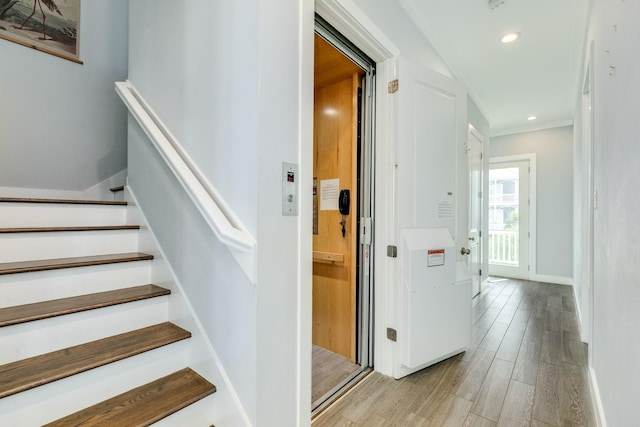 3806 Abalone Rd, Galveston, TX 77554 - stairs with wood finished floors, recessed lighting, and ornamental molding