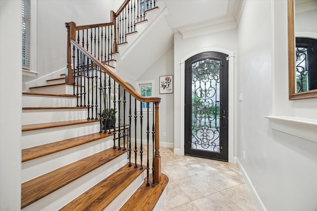 5200 Jackson St, Houston, TX 77004 - tiled entrance foyer featuring crown molding, stairs, and arched walkways