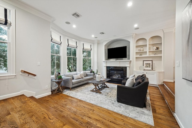 5200 Jackson St, Houston, TX 77004 - living area with wood finished floors, ornamental molding, a high end fireplace, and recessed lighting