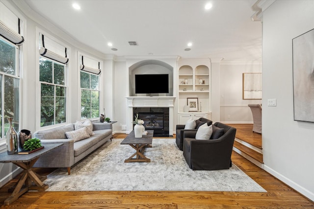 5200 Jackson St, Houston, TX 77004 - living room featuring ornamental molding, recessed lighting, a tiled fireplace, and wood finished floors