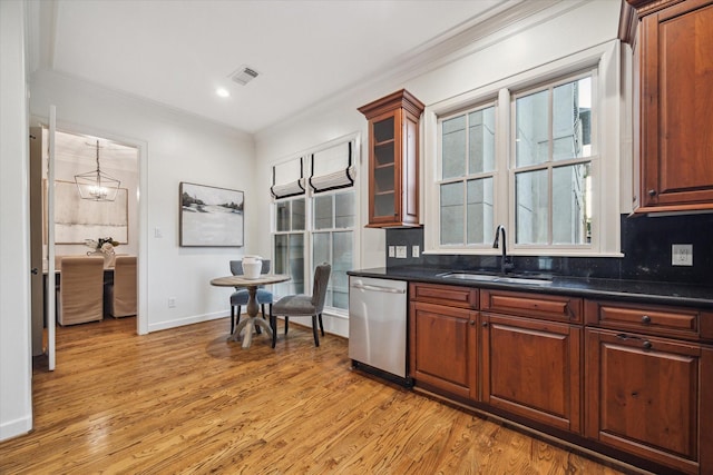5200 Jackson St, Houston, TX 77004 - kitchen featuring dishwasher, crown molding, light wood finished floors, tasteful backsplash, and glass insert cabinets