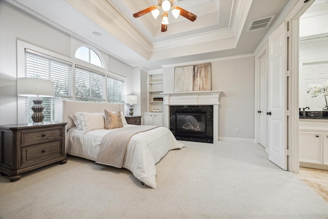 5200 Jackson St, Houston, TX 77004 - bedroom featuring a premium fireplace, a tray ceiling, ornamental molding, light carpet, and ceiling fan