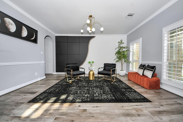 9003 Alps Peak Ct, Richmond, TX 77407 - sitting room featuring plenty of natural light, crown molding, wood finished floors, a chandelier, and arched walkways