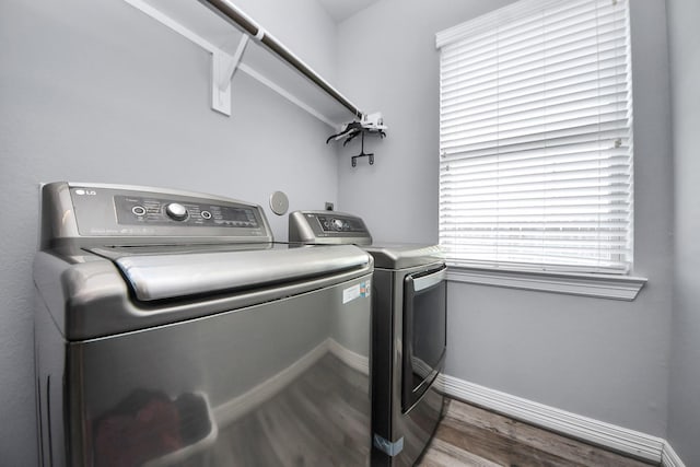 9003 Alps Peak Ct, Richmond, TX 77407 - laundry room featuring independent washer and dryer and wood finished floors