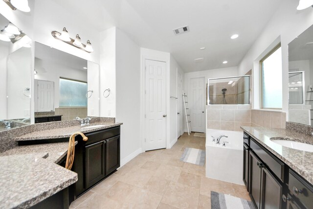 9003 Alps Peak Ct, Richmond, TX 77407 - bathroom with plenty of natural light, two vanities, a shower stall, and recessed lighting