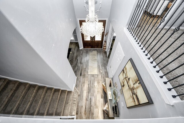 9003 Alps Peak Ct, Richmond, TX 77407 - foyer entrance with a towering ceiling, wood finished floors, stairs, and a chandelier