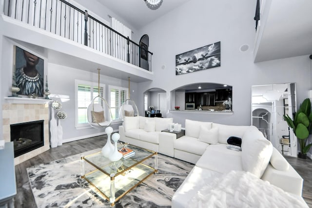 9003 Alps Peak Ct, Richmond, TX 77407 - living room with a high ceiling, a tile fireplace, and wood finished floors