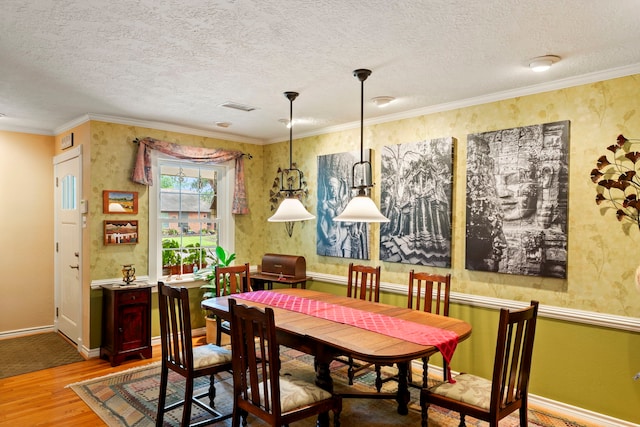 5022 Briarbend Dr, Houston, TX 77035 - dining room with wood finished floors, crown molding, a textured ceiling, and wallpapered walls