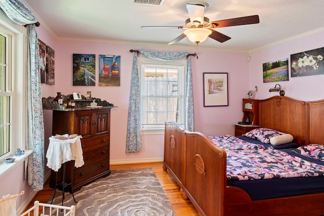 5022 Briarbend Dr, Houston, TX 77035 - bedroom with light wood-style flooring, ornamental molding, and a ceiling fan