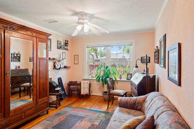 5022 Briarbend Dr, Houston, TX 77035 - living area featuring light wood-style flooring, crown molding, ceiling fan, and a textured ceiling