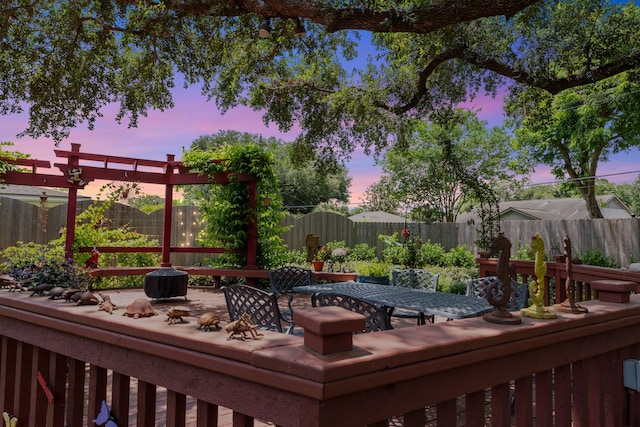 5022 Briarbend Dr, Houston, TX 77035 - deck at dusk featuring outdoor dining space and a fenced backyard