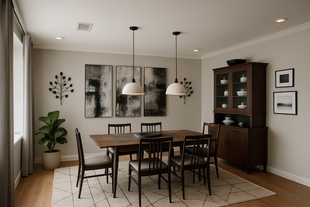 5022 Briarbend Dr, Houston, TX 77035 - dining room with light wood finished floors, ornamental molding, and recessed lighting