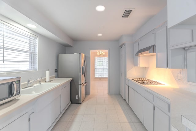 3906 Antoine Dr, Houston, TX 77092 - kitchen featuring appliances with stainless steel finishes, ventilation hood, light countertops, recessed lighting, and light tile patterned floors
