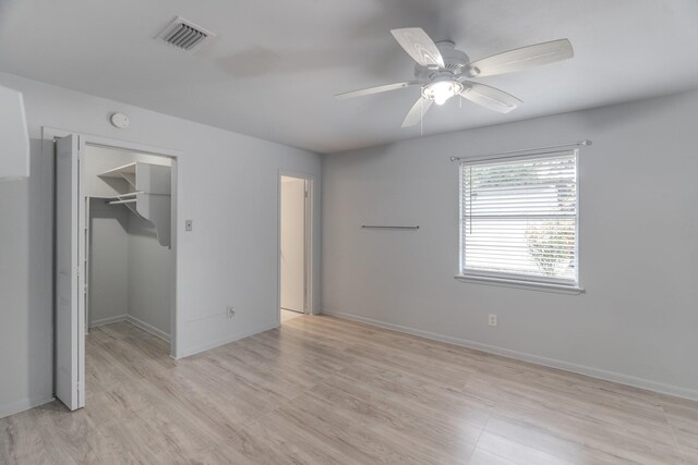 3906 Antoine Dr, Houston, TX 77092 - unfurnished bedroom with a walk in closet, light wood finished floors, a ceiling fan, and a closet