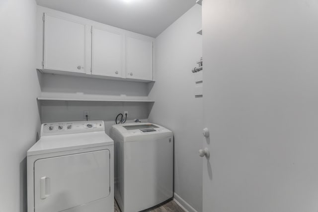 3906 Antoine Dr, Houston, TX 77092 - laundry room with cabinet space, separate washer and dryer, and wood finished floors