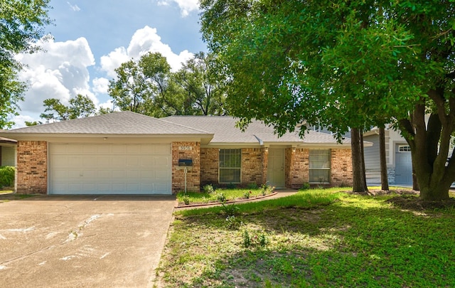 3906 Antoine Dr, Houston, TX 77092 - ranch-style house with brick siding, concrete driveway, and an attached garage