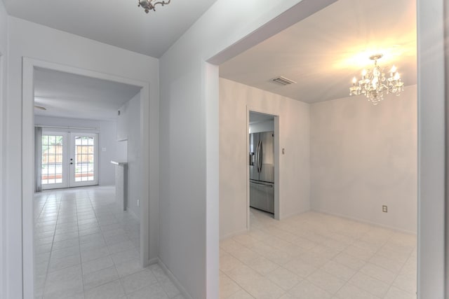3906 Antoine Dr, Houston, TX 77092 - corridor with a chandelier, french doors, and light tile patterned flooring