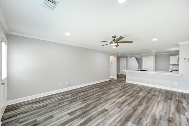 1810 Adobe Stone Dr, Humble, TX 77396 - unfurnished living room featuring ornamental molding, recessed lighting, a ceiling fan, and wood finished floors