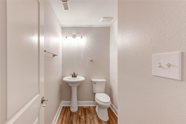 1810 Adobe Stone Dr, Humble, TX 77396 - half bathroom featuring toilet and wood finished floors