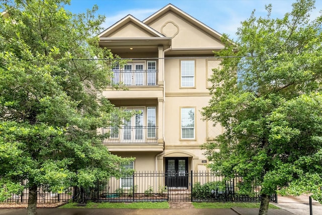 1316 Birdsall St, Houston, TX 77007 - multi unit property with a balcony, french doors, stucco siding, and a fenced front yard