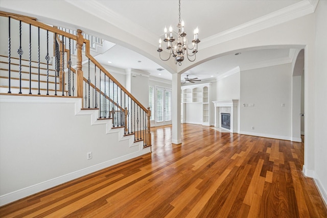 1316 Birdsall St, Houston, TX 77007 - unfurnished living room featuring crown molding, ceiling fan, wood finished floors, stairs, and arched walkways