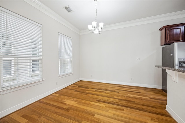 1316 Birdsall St, Houston, TX 77007 - unfurnished dining area featuring a chandelier, light wood finished floors, and ornamental molding